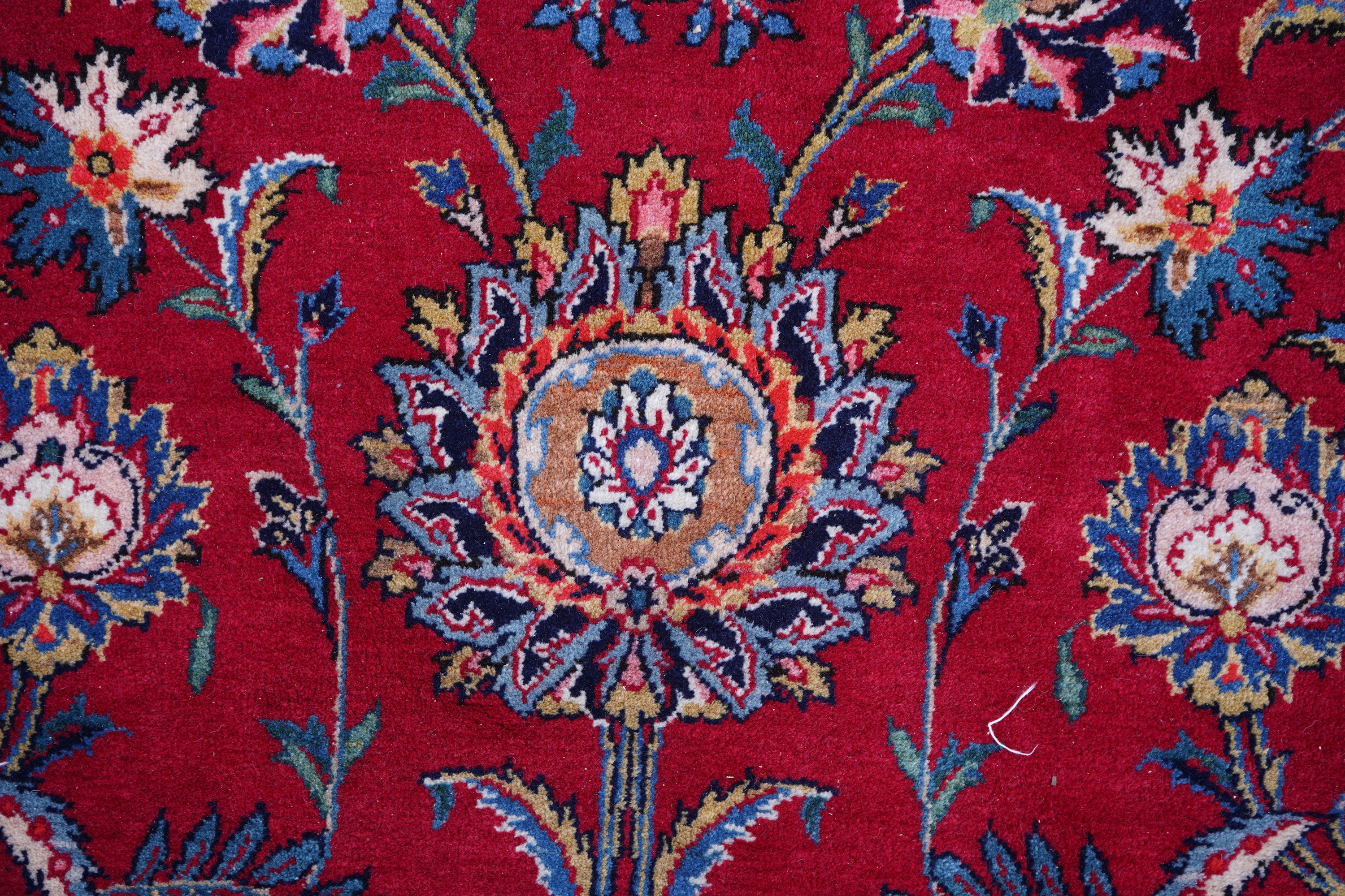 A Kashan burgundy ground carpet